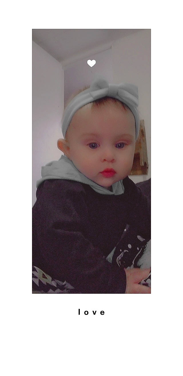Violet is registered to the contest to win money with this photo: baby, baby_toddler_clothing, cap, cheek, child, comfort, eye, eyebrow, fashion_accessory, fur, hood, jacket, outerwear, pattern, person, personal_protective_equipment, portrait_photography, sitting, sleeve, t_shirt