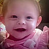 Jocelyn is registered to the contest to win money with this photo: baby, smiling, pink, bows, infant, child, portrait, cute, happy, face, head, clothing, soft_light, closeup, indoors, young, person, female, adorable, toddler