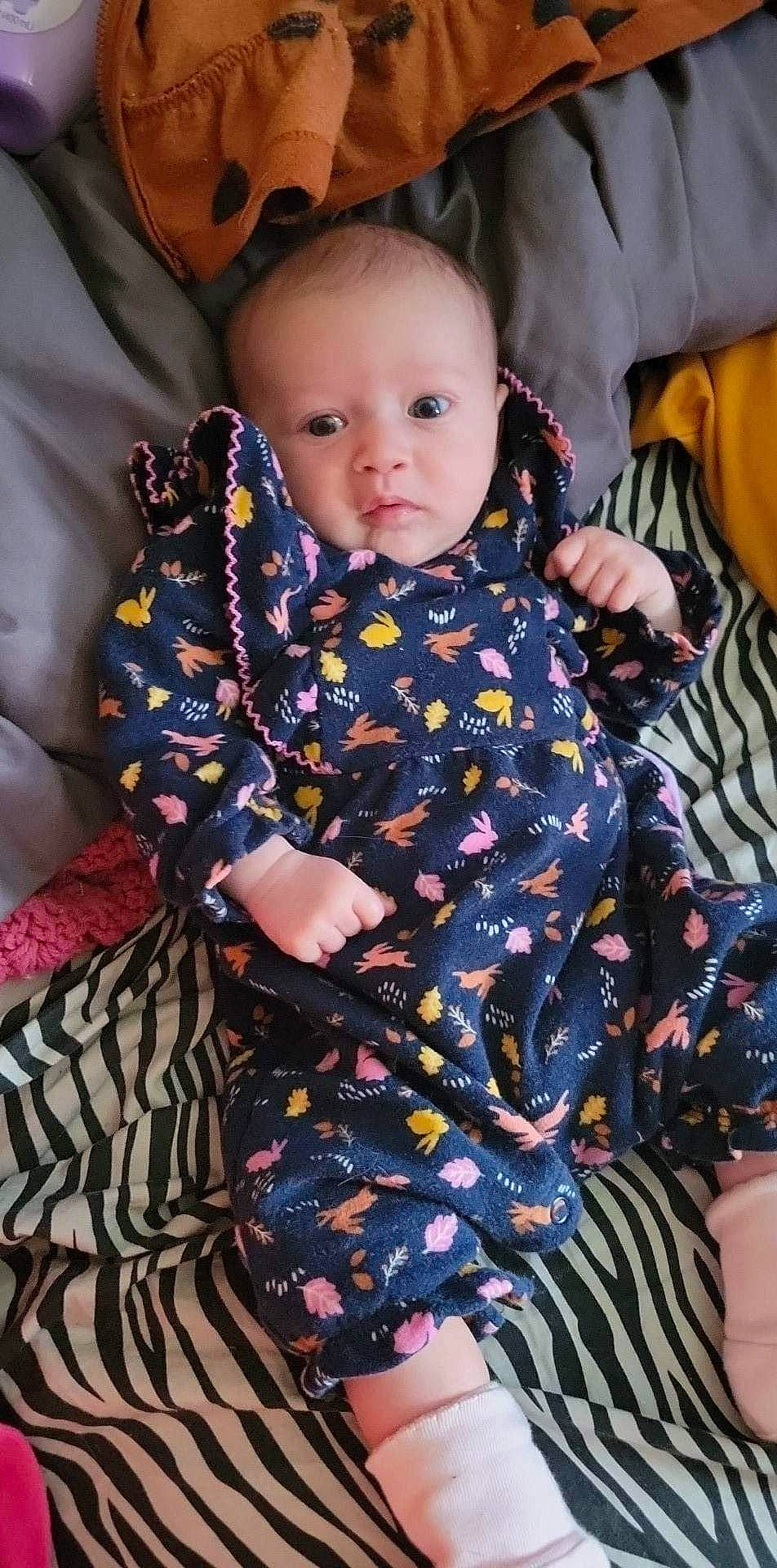 Elizabeth is registered to the contest to win money with this photo: baby, baby_products, baby_toddler_clothing, cheek, child, comfort, day_dress, eye, face, fun, hairstyle, head, iris, linens, magenta, pattern, person, sitting, skin, sleeve