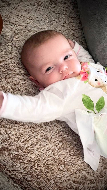 Keissy participe au concours pour gagner de l'argent avec cette photo : baby, baby_toddler_clothing, cheek, child, comfort, eye, face, flooring, grass, iris, linens, lip, pattern, person, petal, plant, sitting, skin, sleeve, toddler