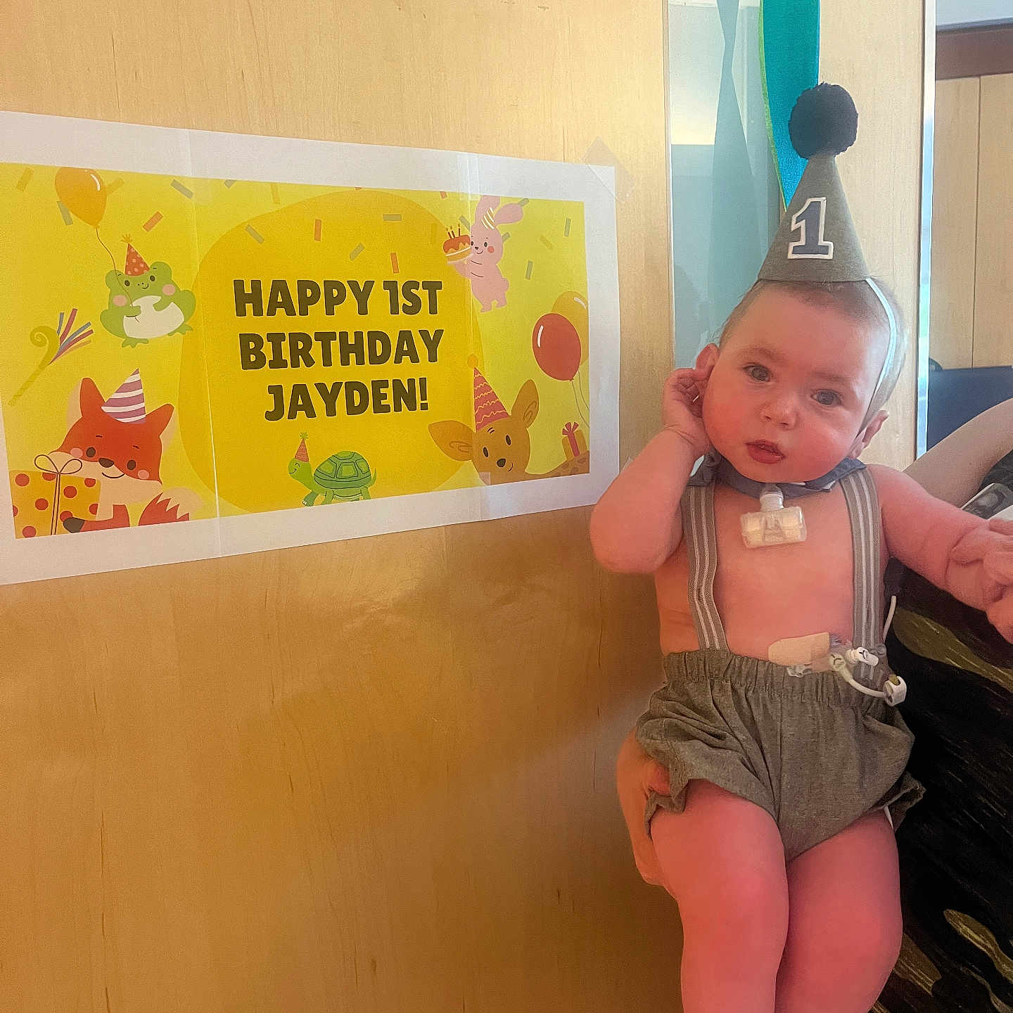 Jayden joined the competition — help win amazing prizes! baby, balloon, bodypart, cap, clothing, face, finger, furniture, hand, hat, head, indoors, partyhat, person, photography, plywood, portrait, shorts, swimwear, wood