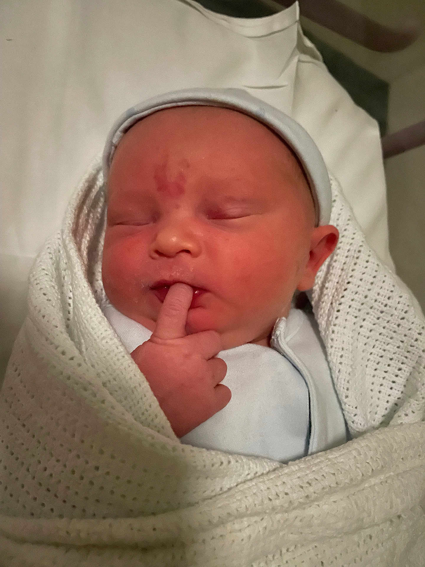 Jacob is registered to the contest to win money with this photo: newborn, baby, infant, sleeping, wrapped, blanket, white, knitted, finger, hat, cute, peaceful, indoors, bed, soft, portrait, child, person, newborn_clothing, gentle
