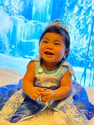 Natalie is registered to the contest to win money with this photo: baby_toddler_clothing, blue, child, electric_blue, event, flash_photography, fun, grass, happy, iris, leisure, people_in_nature, person, recreation, sitting, smile, summer, toddler, vacation, water