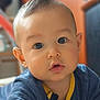 baby, child, face, eyes, blue_clothing, indoor, portrait, cute, infant, curious, young_child, chubby_cheeks, long_sleeve, soft_light, close_up, person, head, skin, expression, toddler