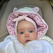 Eloïse participe au concours pour gagner de l'argent avec cette photo : baby, infant, blanket, hood, pink, white, ears, clothing, face, portrait, cute, child, person, newborn, soft, warm, closeup, expression, indoors, seated