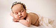 Eloïse participe au concours pour gagner de l'argent avec cette photo : baby, sleeping, infant, flower_headband, soft_texture, white_background, peaceful, portrait, newborn, skin, hands, face, closed_eyes, cute, resting, soft_lighting, child, tender, calm, napping