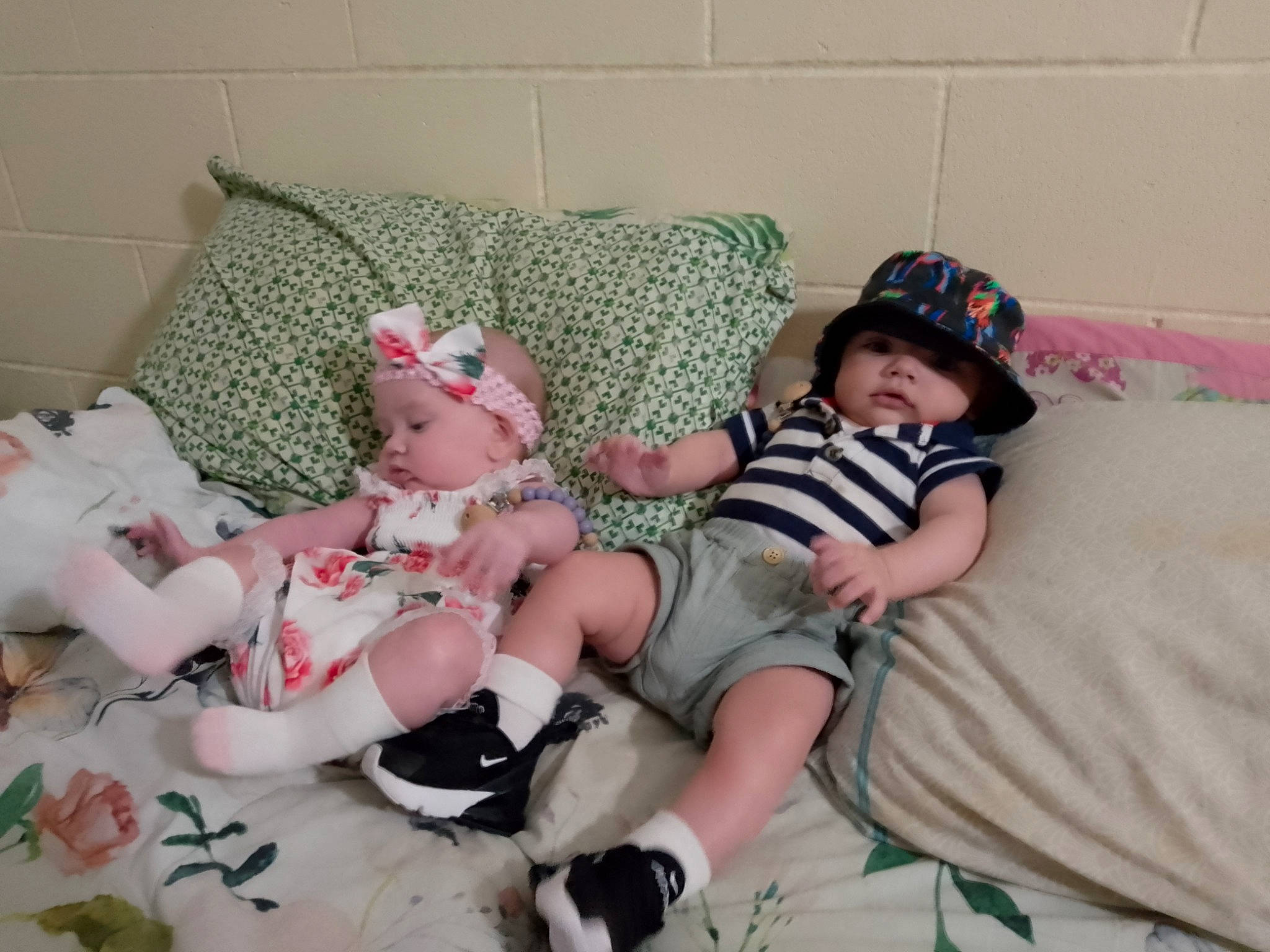 Aryah is registered to the contest to win money with this photo: baby, baby_toddler_clothing, carmine, child, comfort, couch, finger, hat, headgear, headwear, human_leg, lap, linens, pattern, person, pink, room, skin, sock, textile