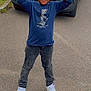 Jayden participe au concours pour gagner de l'argent avec cette photo : blue_shirt, boy, casual_clothing, child, daytime, fun, hands_up, happy, jeans, joyful, outdoor, person, playful_pose, road, smiling, standing, street, van, white_sneakers, young