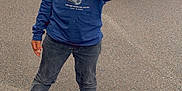 Jayden participe au concours pour gagner de l'argent avec cette photo : blue_shirt, boy, casual_clothing, child, daylight, happy, jeans, necklace, outdoor, person, road, sidewalk, smiling, sneakers, standing, street, thumbs_up, urban, van, vehicle