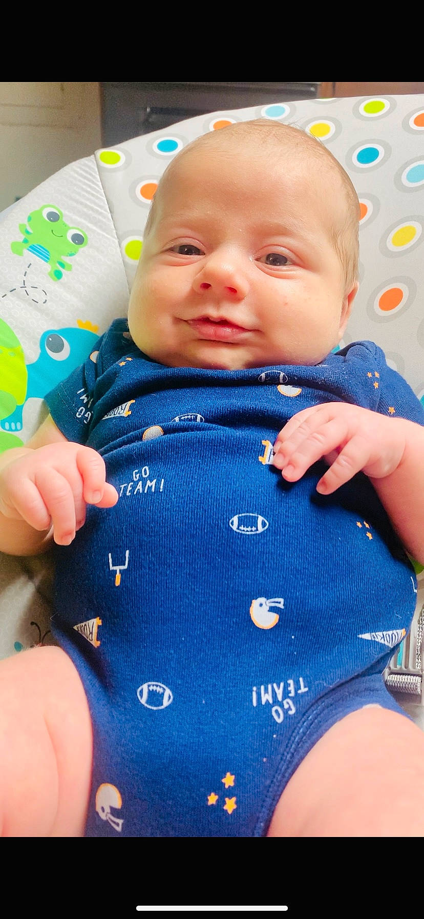 Micah is registered to the contest to win money with this photo: baby, baby_products, baby_toddler_clothing, blue, cheek, child, finger, hand, human, nail, nose, person, polka_dot, skin, sleeve, thumb, toddler