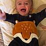 baby, infant, smiling, happy, cute, child, blanket, soft, fox, animal_design, clothing, bedroom, indoors, star, pattern, playful, portrait, young, toddler, cozy