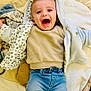 Léoh a rejoint le concours — aidez-le/la à gagner de superbes lots ! baby, child, smiling, happy, jeans, hooded_jacket, blanket, soft_toy, socks, infant, cute, laying_down, indoors, face, clothing, joy, expression, toddler, warm, cozy