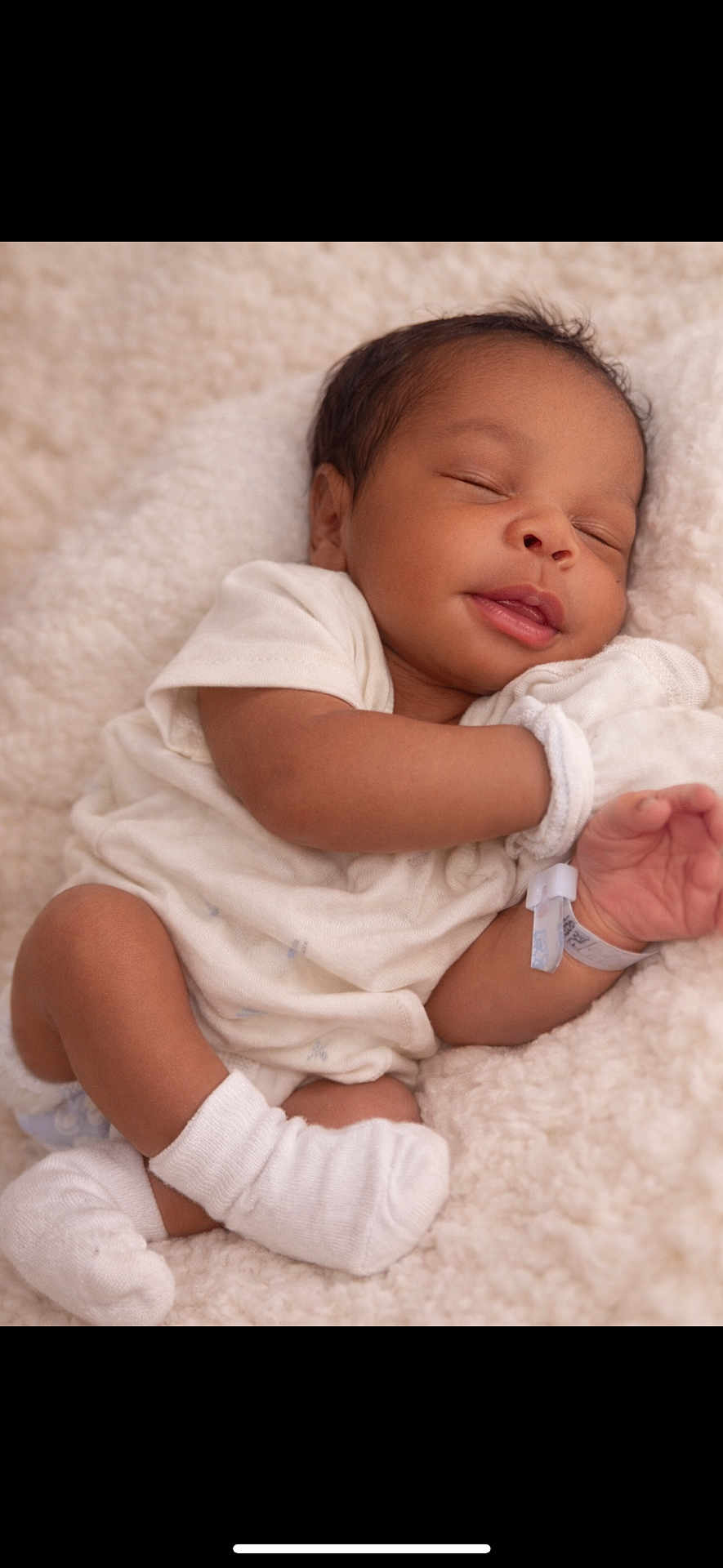 Makai Dior is registered to the contest to win money with this photo: baby, child, closeup, cozy, cute, foot, hand, hospital_wristband, infant, newborn, onesie, peaceful, portrait, relaxation, resting, skin, sleep, sleeping, soft_blanket, white_socks