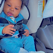 Makai Dior is registered to the contest to win money with this photo: baby, blue_outfit, car_interior, car_seat, child, clothing, curly_hair, cute, face, footwear, hands, indoors, infant, portrait, safety, seatbelt, sitting, smiling, white_sneakers, young_child