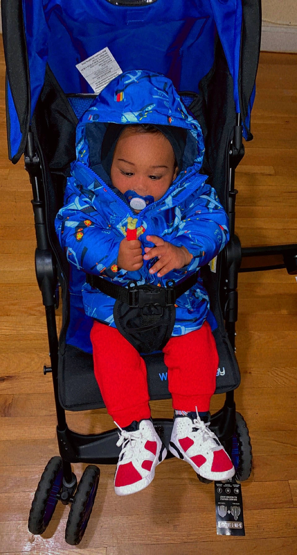 Jabari is registered to the contest to win money with this photo: baby, baby_carriage, baby_products, baby_safety, baby_toddler_clothing, bag, blue, chair, child, comfort, electric_blue, fashion_accessory, fun, person, sitting, tire, toddler, wheel