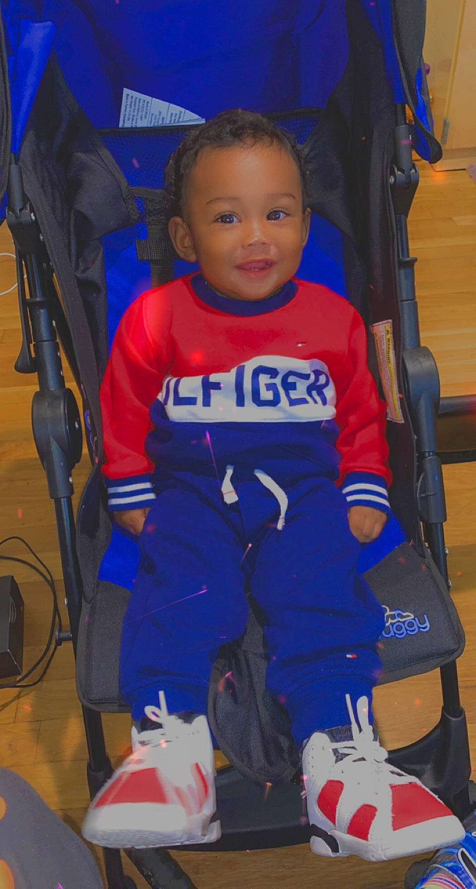 Jabari is registered to the contest to win money with this photo: baby, baby_carriage, baby_products, blue, child, electric_blue, flooring, fun, jersey, joy, person, personal_protective_equipment, player, product, recreation, service, smile, sports, sports_gear, sports_uniform
