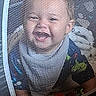 Lucius is registered to the contest to win money with this photo: baby, babywear, candid, cheerful, child, closeup, clothing, curious, fabric, face, happy, head, indoor, infant, mesh_netting, net, playpen, portrait, smiling, toy
