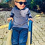accessories, blonde, boy, child, clothing, face, footwear, hair, head, jeans, male, pants, person, photography, portrait, shoe, sitting, sleeve, sunglasses, toy