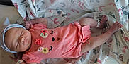 Tellisa is registered to the contest to win money with this photo: newborn, baby, sleeping, hospital, blanket, footprints, onesie, pink, hat, bassinet, infant, wrapping, cute, peaceful, resting, person, bed, hospital_wristband, nursery, soft