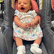 Lilyanah Andre joined the competition — help win amazing prizes! baby, infant, smiling, car_seat, dress, white_socks, happy, child, cute, indoor, person, seat, clothing, fabric, comfort, head, hands, legs, footwear, portrait