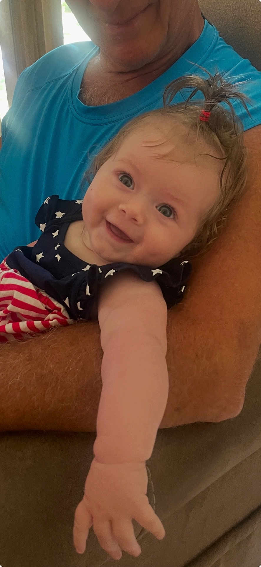 Sophia joined the competition — help win amazing prizes! baby, child, smile, face, arm, person, blue_shirt, hair, pony_tail, indoor, couch, holding, happy, skin, closeup, infant, human, cute, expression, portrait