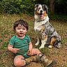 Kodi is registered to the contest to win money with this photo: toddler, dog, australian_shepherd, muddy, outdoor, grass, boots, green_onesie, happy, tongue_out, child, nature, playful, forest, pet, sitting, grass_and_dirt, cute, young_child, animal