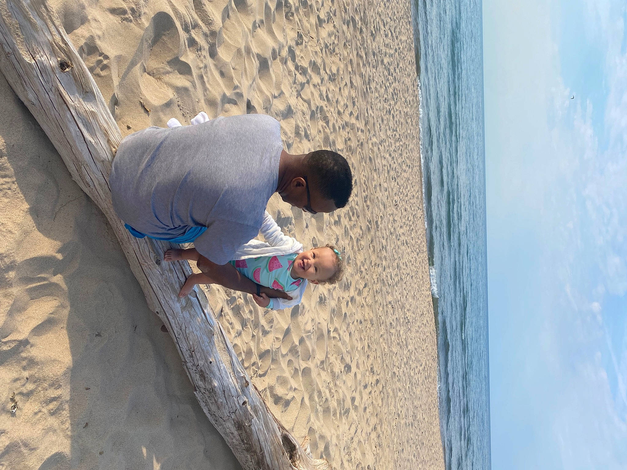 Bella is registered to the contest to win money with this photo: adventure, azure, beach, body_of_water, cloud, concrete, elbow, fun, human_leg, joy, landscape, leisure, person, recreation, rock, sand, sky, slope, t_shirt, under_exposed