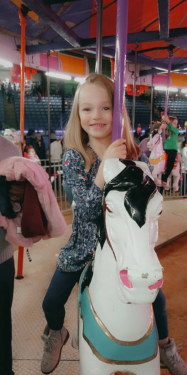 Ansley joined the competition — help win amazing prizes! blurred, child, event, fashion_accessory, fawn, fun, hairstyle, happy, joy, leash, leisure, livestock, person, pink, public_event, recreation, smile, street_fashion, t_shirt, toddler
