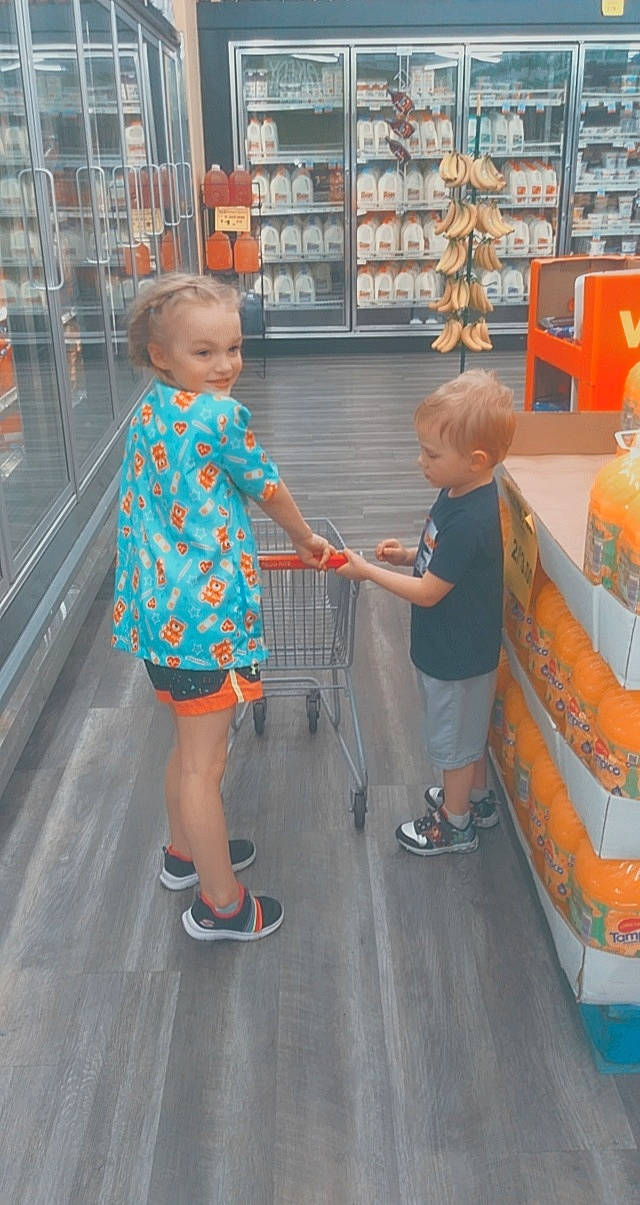 Ansley is registered to the contest to win money with this photo: child, convenience_store, customer, flooring, fun, human_leg, leisure, pattern, person, play, retail, sandal, service, shelf, shelving, shopping, shorts, sidewalk, standing, toddler