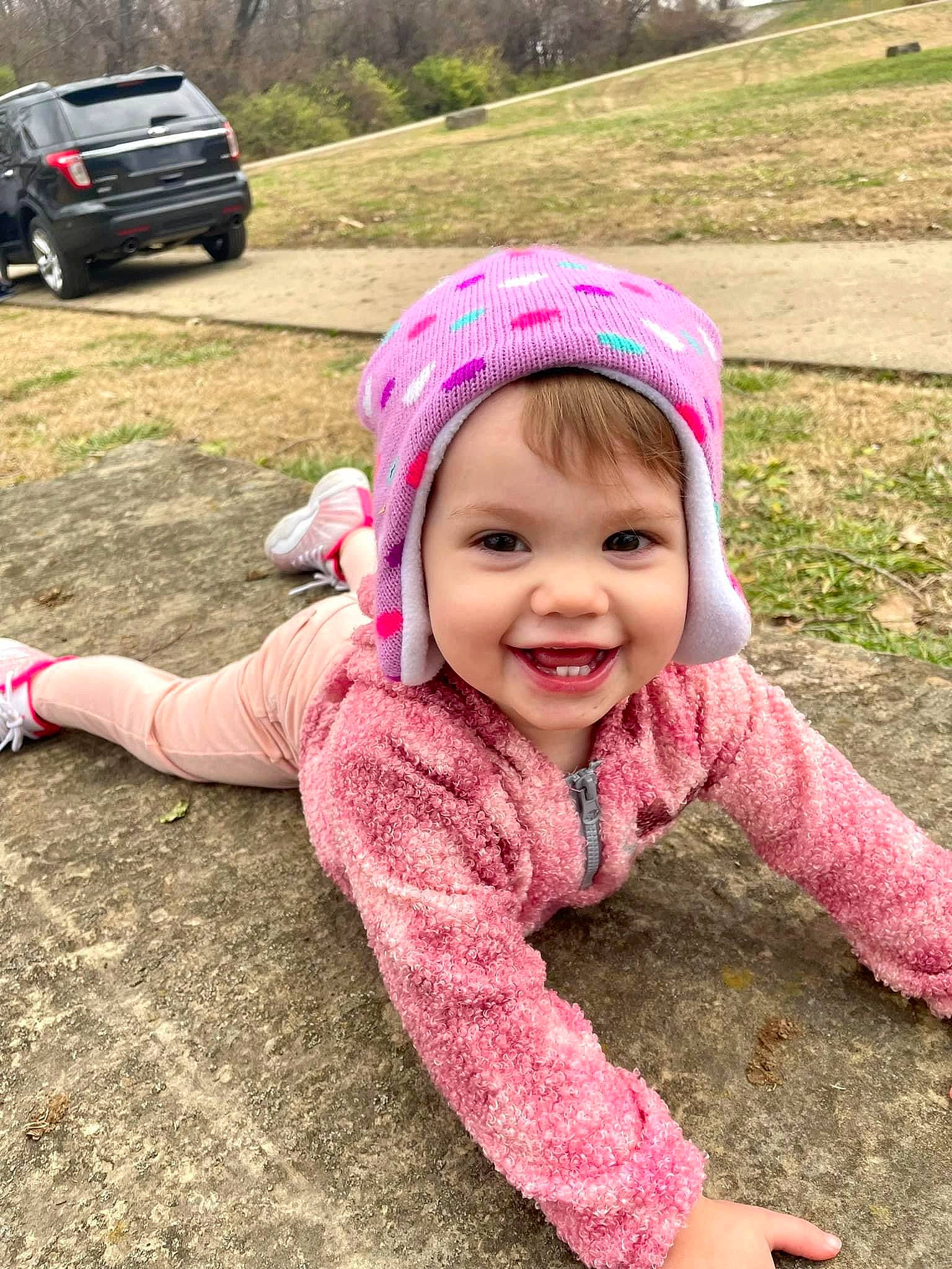 Amaryllis joined the competition — help win amazing prizes! automotive_lighting, automotive_tire, baby_toddler_clothing, cap, car, grass, happy, headgear, headwear, jacket, joy, mammal, outerwear, person, pink, plant, public_space, smile, tire, toddler