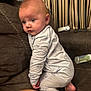 Kaisen is registered to the contest to win money with this photo: baby, child, pajamas, couch, furniture, face, indoor, curtains, bottle, foot, hand, person, home, striped_curtains, sitting, infant, clothing, looking, soft_lighting, cozy