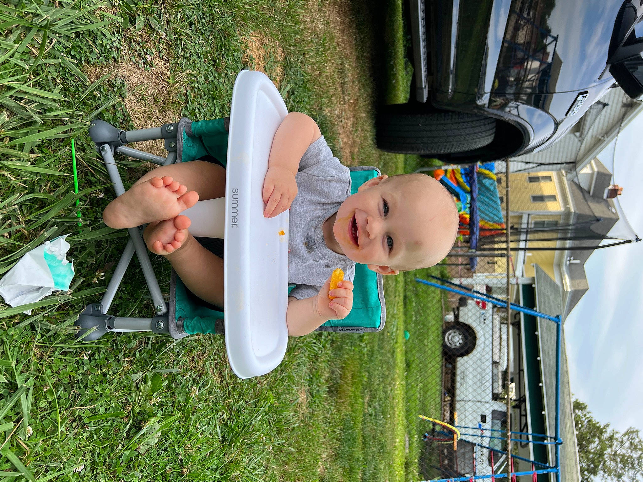 Brendon joined the competition — help win amazing prizes! automotive_exterior, baby, baby_products, car, child, family_car, fun, grass, green, hat, joy, leisure, person, plant, recreation, sky, tire, toddler, tree, vehicle_door
