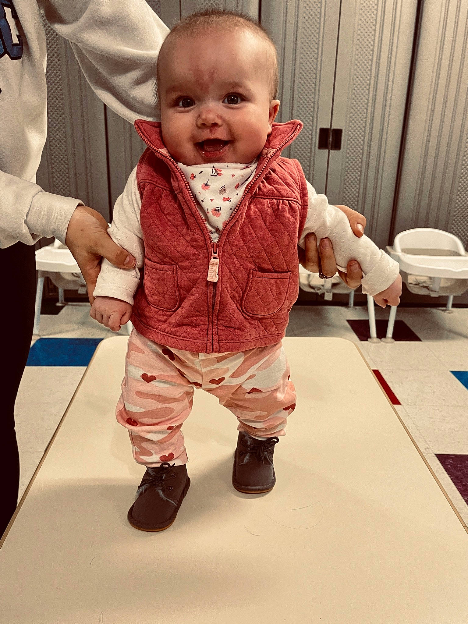 Paislee is registered to the contest to win money with this photo: baby, baby_toddler_clothing, cheek, child, flooring, fun, gesture, hand, happy, hardwood, head, holding_hands, nose, person, sitting, skin, sleeve, smile, thumb, toddler