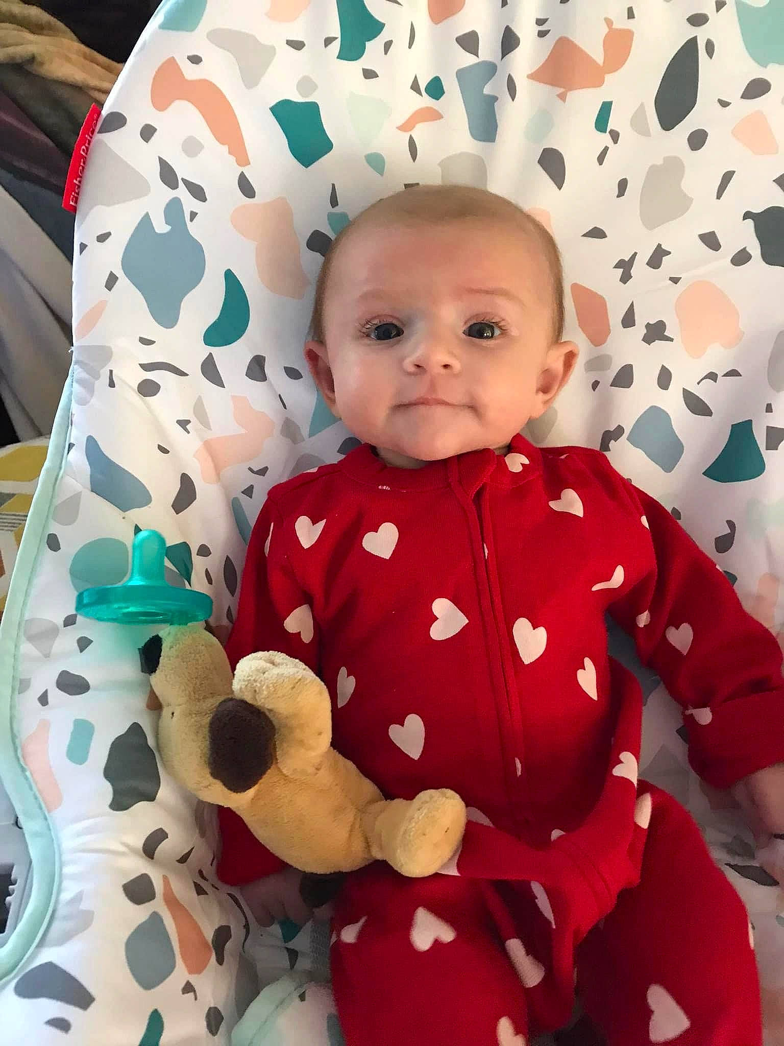 Micaela is registered to the contest to win money with this photo: baby, baby_toddler_clothing, collar, comfort, eye, face, facial_expression, hairstyle, head, human, organ, outerwear, person, pink, product, skin, sleeve, smile, t_shirt, textile