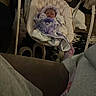 baby, infant, sleeping, bouncer, blanket, purple_clothing, toy, mobile, indoor, home, living_room, cozy, portrait, face, closed_eyes, newborn, furniture, soft_lighting, seated, family