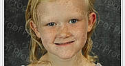 Athena is registered to the contest to win money with this photo: child, girl, portrait, smiling, freckles, blonde_hair, blue_eyes, floral_dress, studio, headshot, face, person, photography, dark_background, shoulders, looking_at_camera, happy, close_up, watermark, proof_text