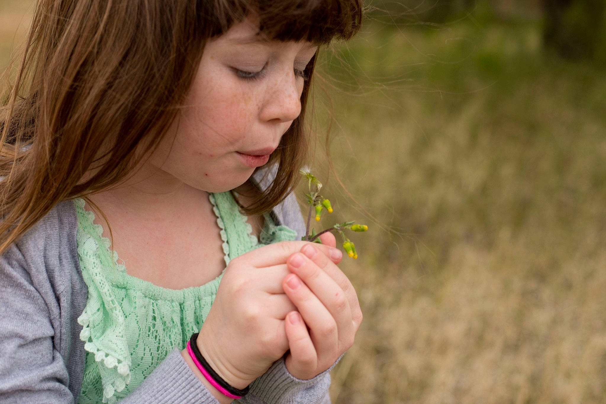 Annaliese joined the competition — help win amazing prizes! botany, brown_hair, child, dandelion, finger, flower, gesture, hand, leaf, person, photography, plant, skin, smile, spring, thumb, toddler
