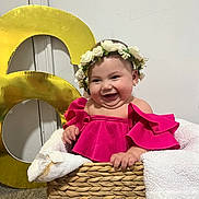 Adry Sophia joined the competition — help win amazing prizes! baby, child, smile, flower_crown, pink_clothing, basket, blanket, indoor, happy, cute, portrait, celebration, number_6, floor, woven_basket, toddler, person, head, face, joy