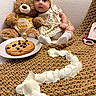 Alayna joined the competition — help win amazing prizes! baby, birthday, blanket, candle, child, cookie, couch, cozy, dessert, golden_outfit, headband, indoor, portrait, rose_petals, sitting, smiling, socks, teddy_bear, toy, wide_eyed