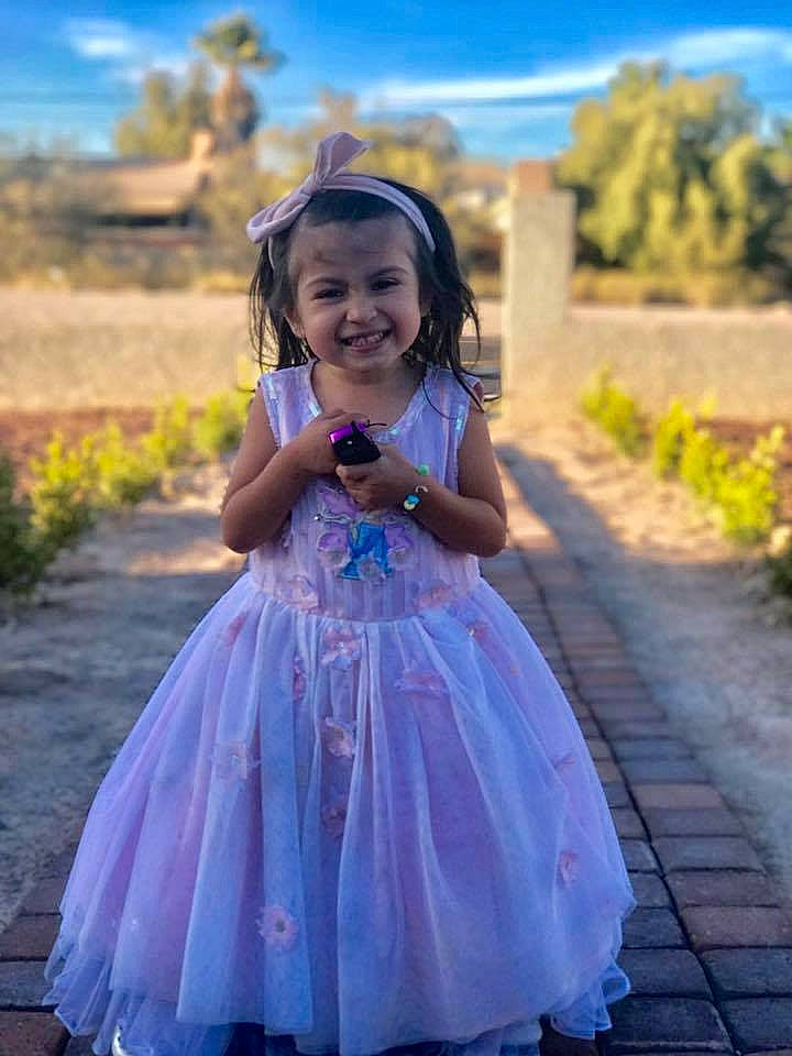 Megan is registered to the contest to win money with this photo: blue, child, costume, dance_dress, dress, flower, flower_girl, fun, girl, gown, hair_accessory, happiness, joy, lady, lavender, person, plant, purple, smile, toddler