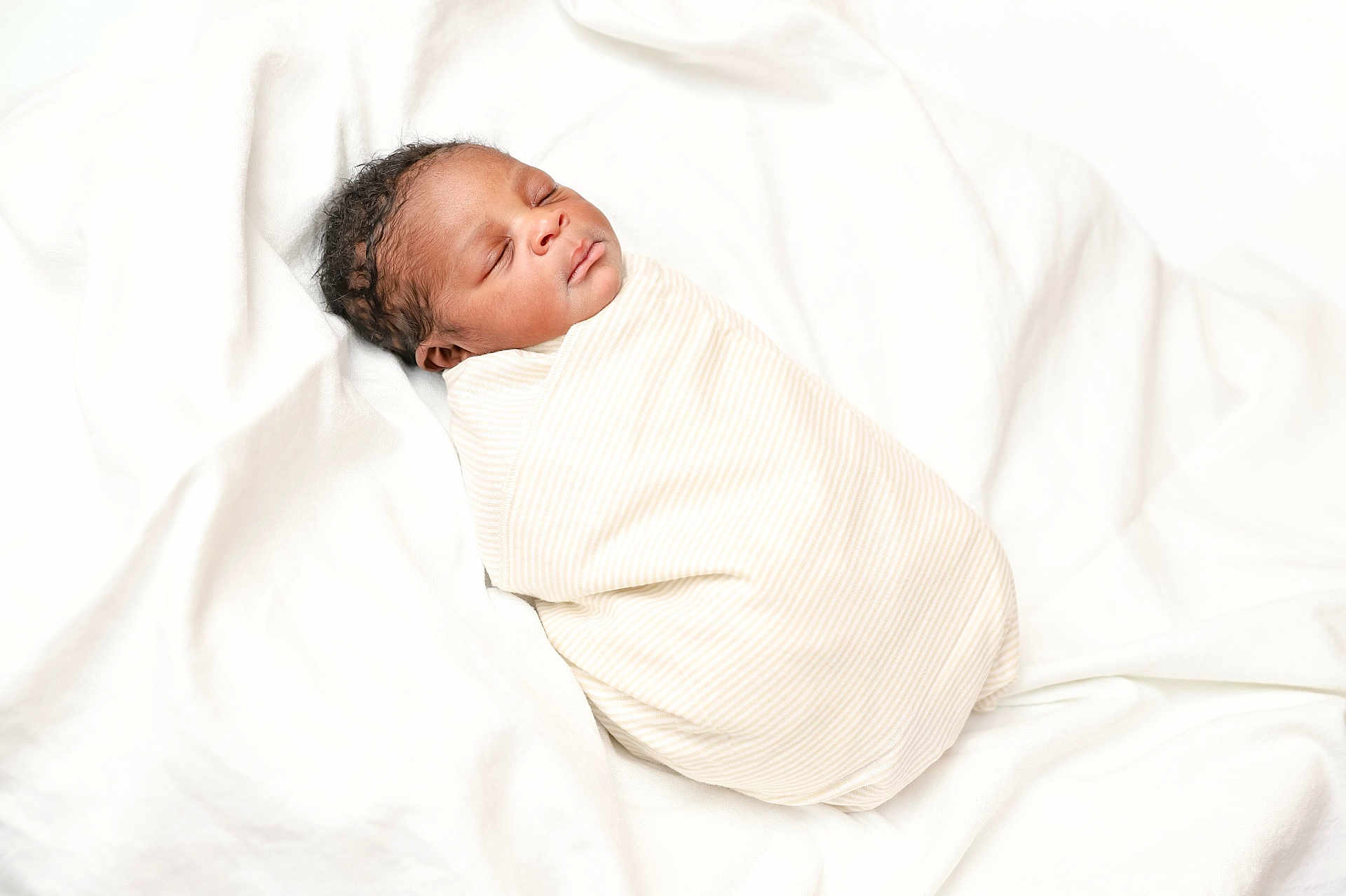 Ugochukwu joined the competition — help win amazing prizes! newborn, baby, sleeping, swaddled, blanket, infant, soft, white, peaceful, resting, cute, portrait, child, cozy, wrapped, tiny, head, face, peace, comfort
