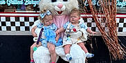 Michael joined the competition — help win amazing prizes! child, toddler, easter_bunny, mascot, costume, toy_basket, outdoor, sidewalk, decorations, curtain, checkered_pattern, window, storefront, pink, white, blue_clothing, baby_shoes, expression, public, holiday