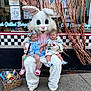 Michael is registered to the contest to win money with this photo: child, toddler, person, mascot, easter_bunny, costume, toy_basket, sidewalk, outdoor, storefront, streamers, window, decorations, clothing, pink_shoes, blue_dress, white_costume, expression, holding, cute