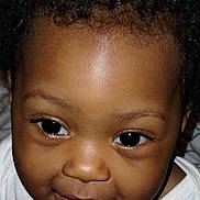 Elizabeth Grace is registered to the contest to win money with this photo: baby, child, face, smile, curly_hair, eyes, skin, portrait, cute, infant, closeup, white_shirt, young_child, expression, cheeks, head, person, human, baby_face, adorable