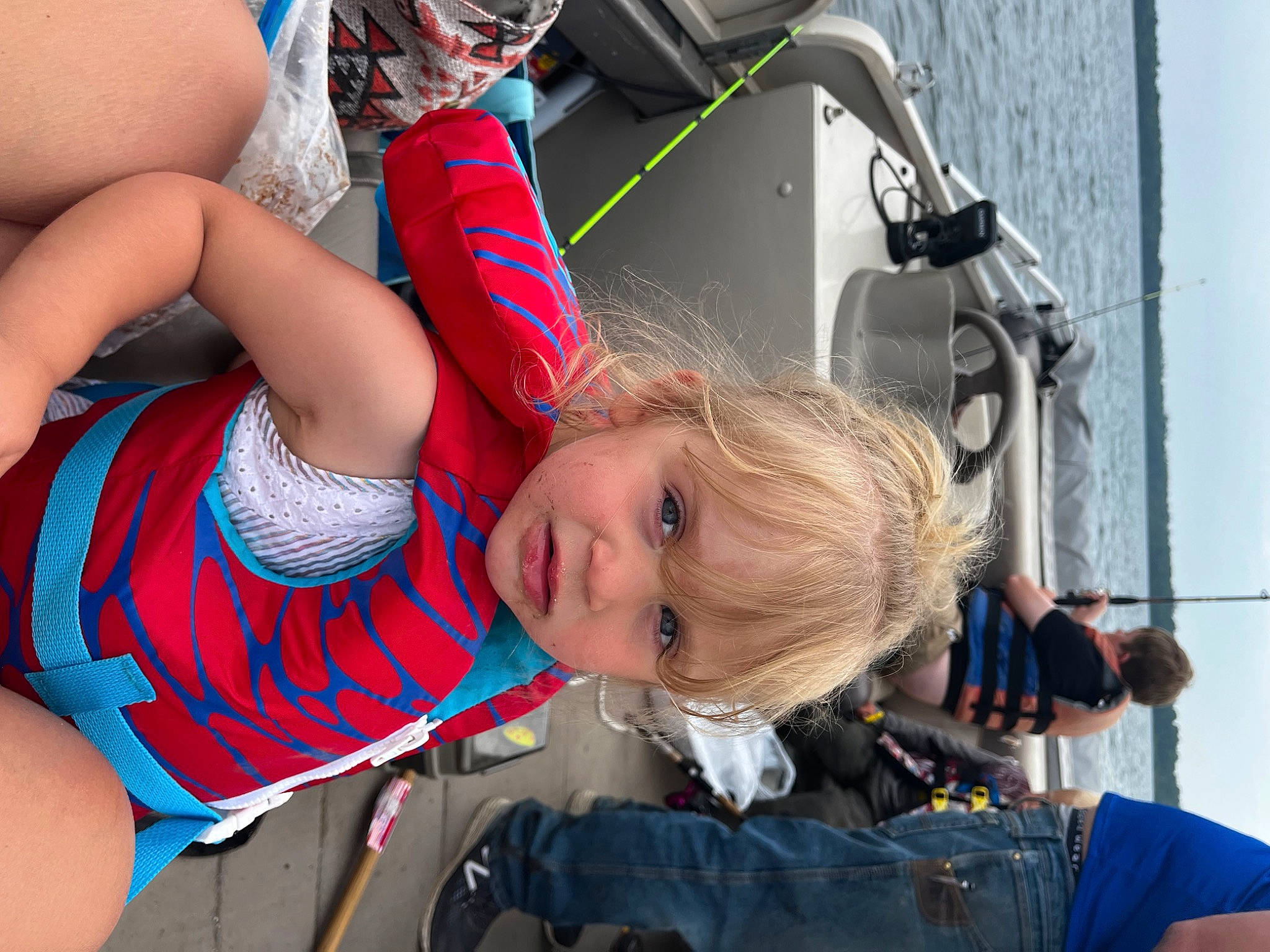 Freya is registered to the contest to win money with this photo: blond, blue, child, electric_blue, eyewear, fun, hairstyle, happy, human_leg, leisure, person, personal_protective_equipment, recreation, shorts, sitting, sky, thigh, toddler, travel, tree