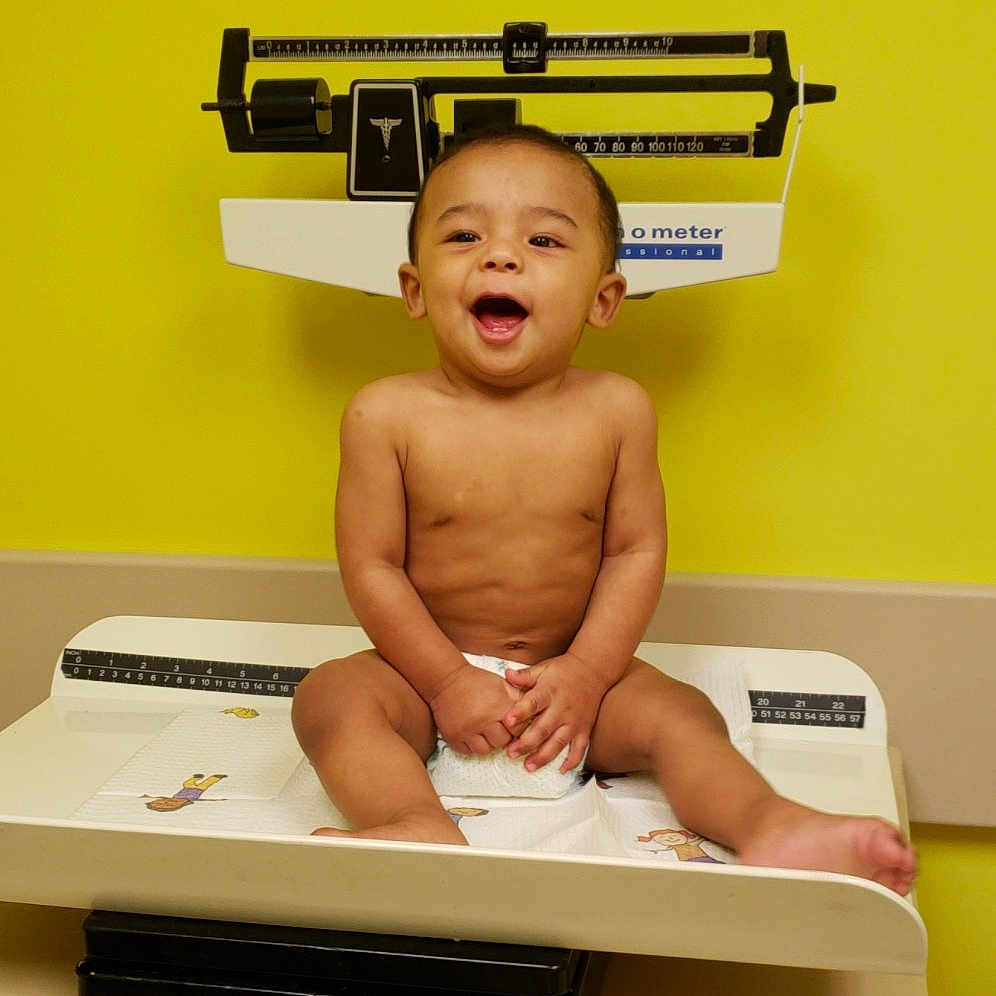 Santiago is registered to the contest to win money with this photo: boy, desk, furniture, leg, muscle, person, sitting, table