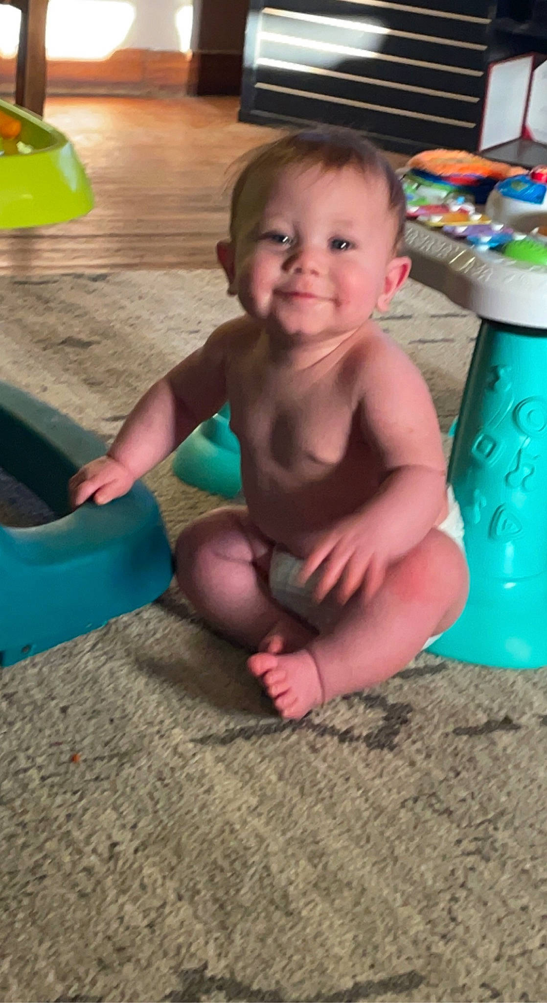 Raiden is registered to the contest to win money with this photo: baby, baby_products, barefoot, child, flooring, foot, fun, grass, green, happy, human_leg, joy, leisure, person, play, sitting, skin, smile, thigh, thumb