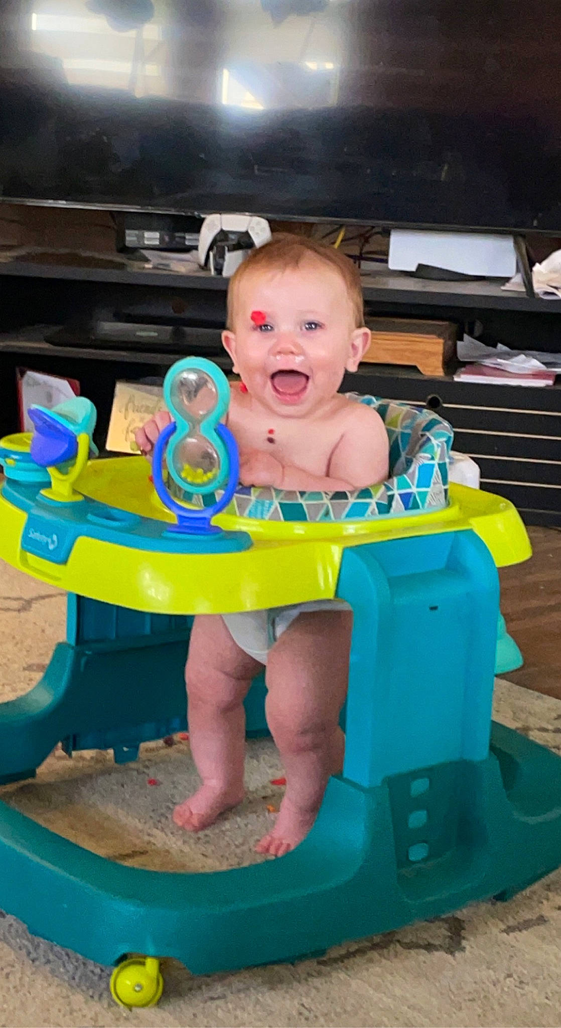 Raiden is registered to the contest to win money with this photo: baby, baby_products, baby_toddler_clothing, baby_toys, chair, child, electric_blue, fun, happy, leisure, person, plastic, play, product, recreation, sandal, sitting, smile, t_shirt, toddler