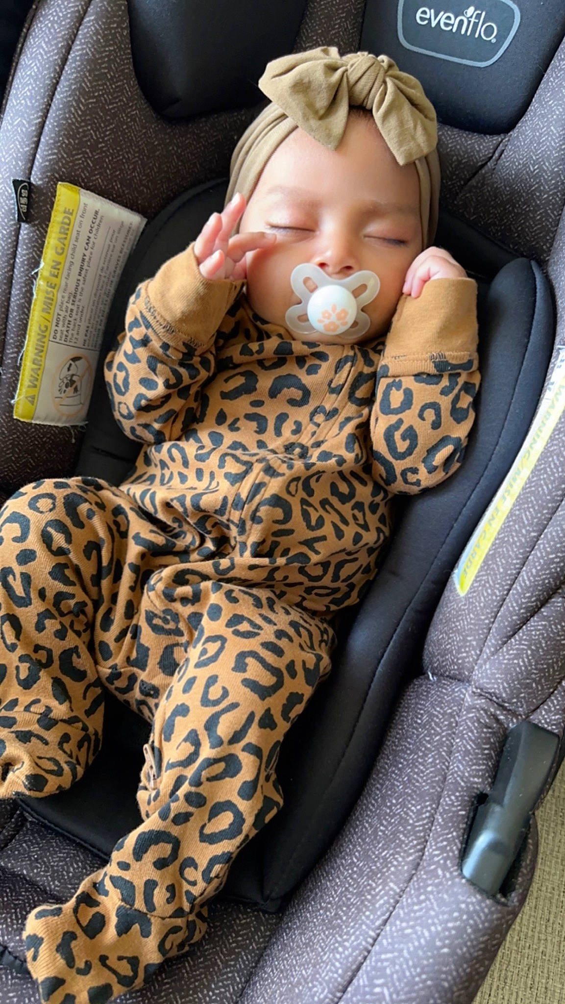 Myla is registered to the contest to win money with this photo: auto_part, automotive_wheel_system, baby, baby_products, car_seat, car_seat_cover, carmine, comfort, doll, head_restraint, human_leg, knee, lap, pattern, person, sitting, steering_wheel, stuffed_toy, textile, thigh