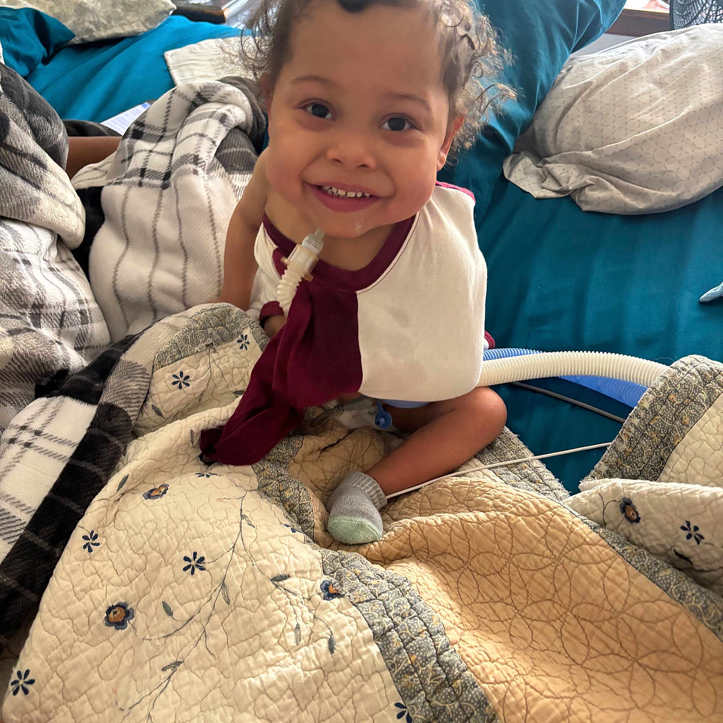 Mason is registered to the contest to win money with this photo: baby, bed, blanket, bodypart, child, couch, cushion, face, female, furniture, girl, happy, head, homedecor, linen, person, photography, portrait, quilt, smile